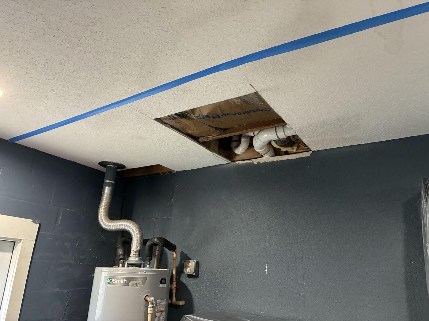 Ceiling opened up for repair around water heater vent